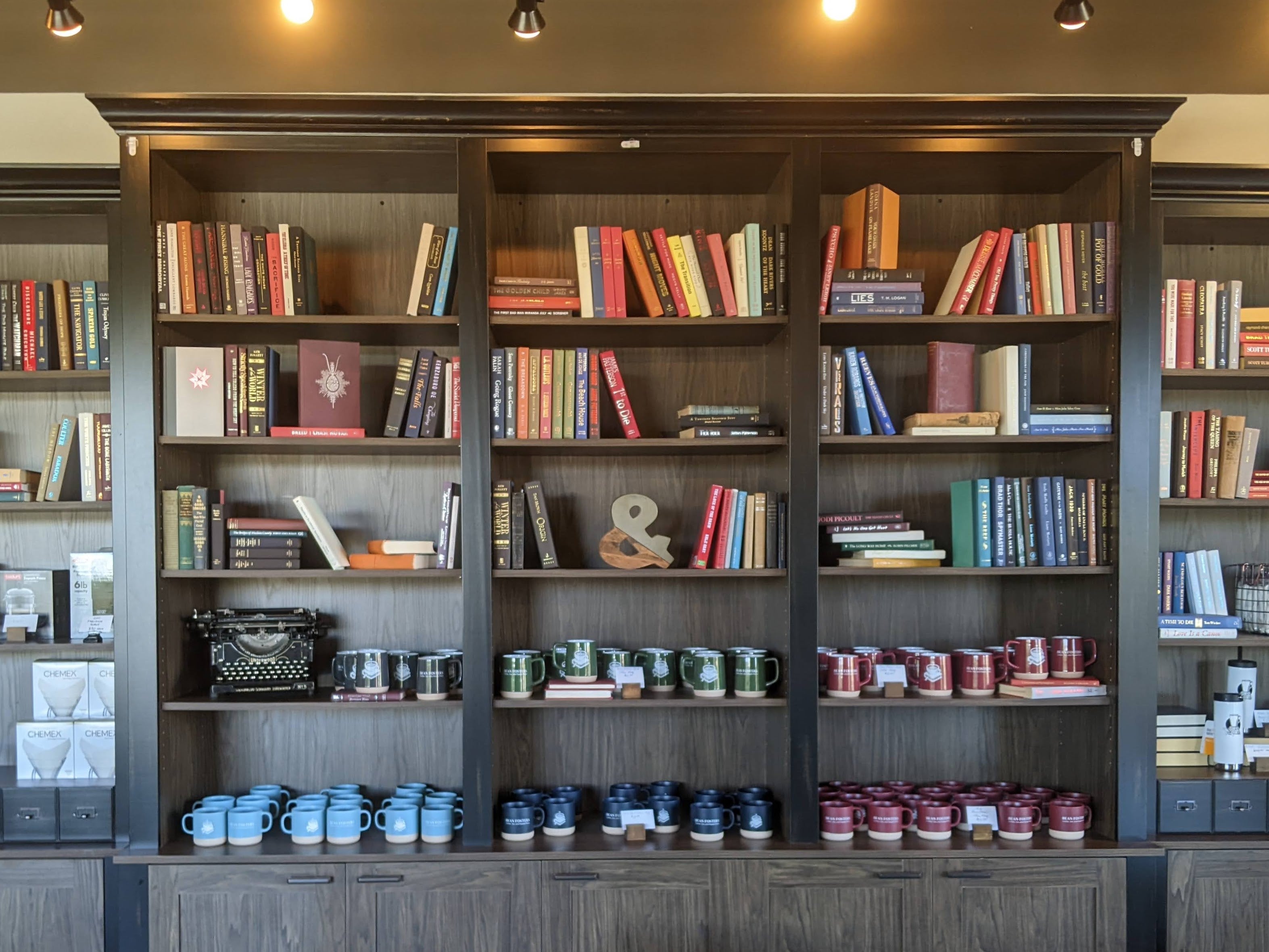Shelves of books and mugs and trinkets.